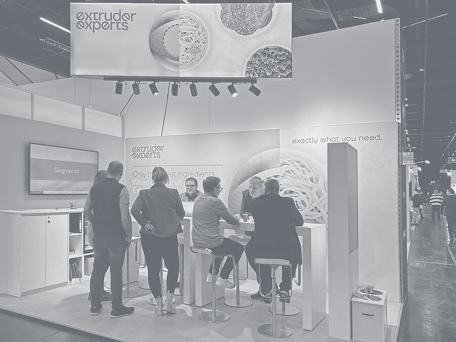 Extruder Experts employees talking to interested parties at their own stand at Anuga FoodTec 2024