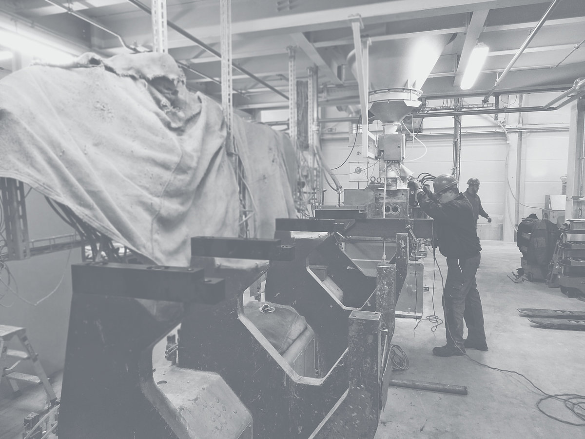 Employee in a workshop operates a machine